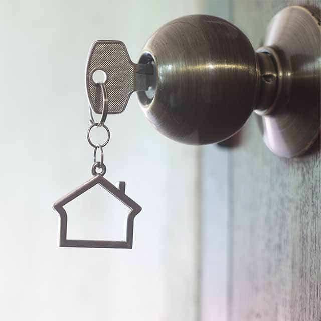 Key with house keychain in door handle